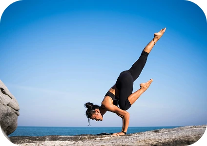 Lady doing yoga on mountain top